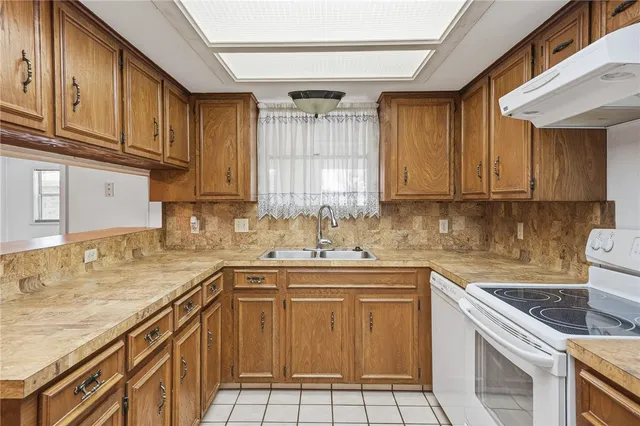 a kitchen with a sink stove top oven and cabinets