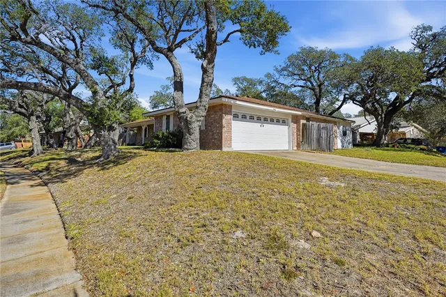 a view of a yard with a house and large trees