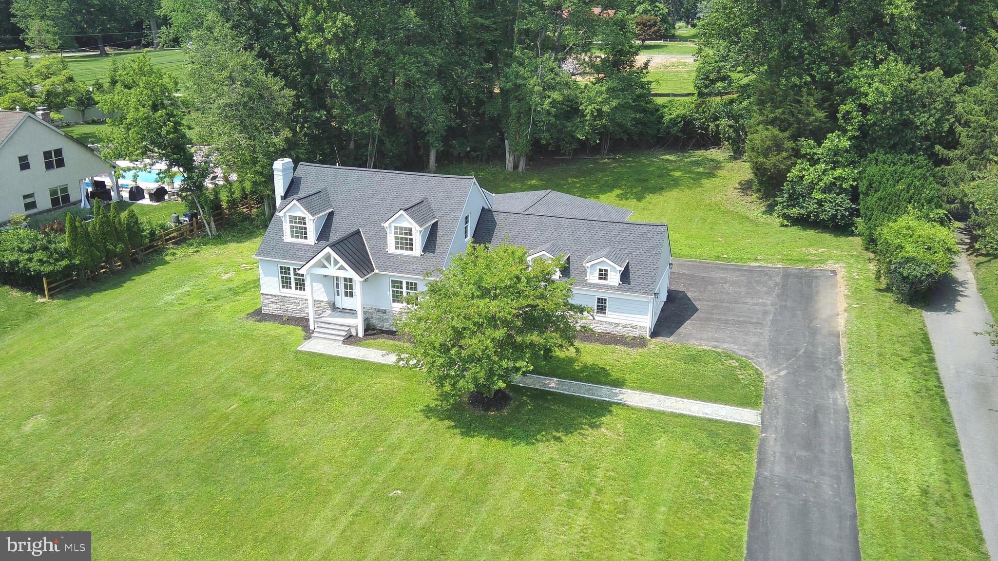 an aerial view of a house with swimming pool garden and patio