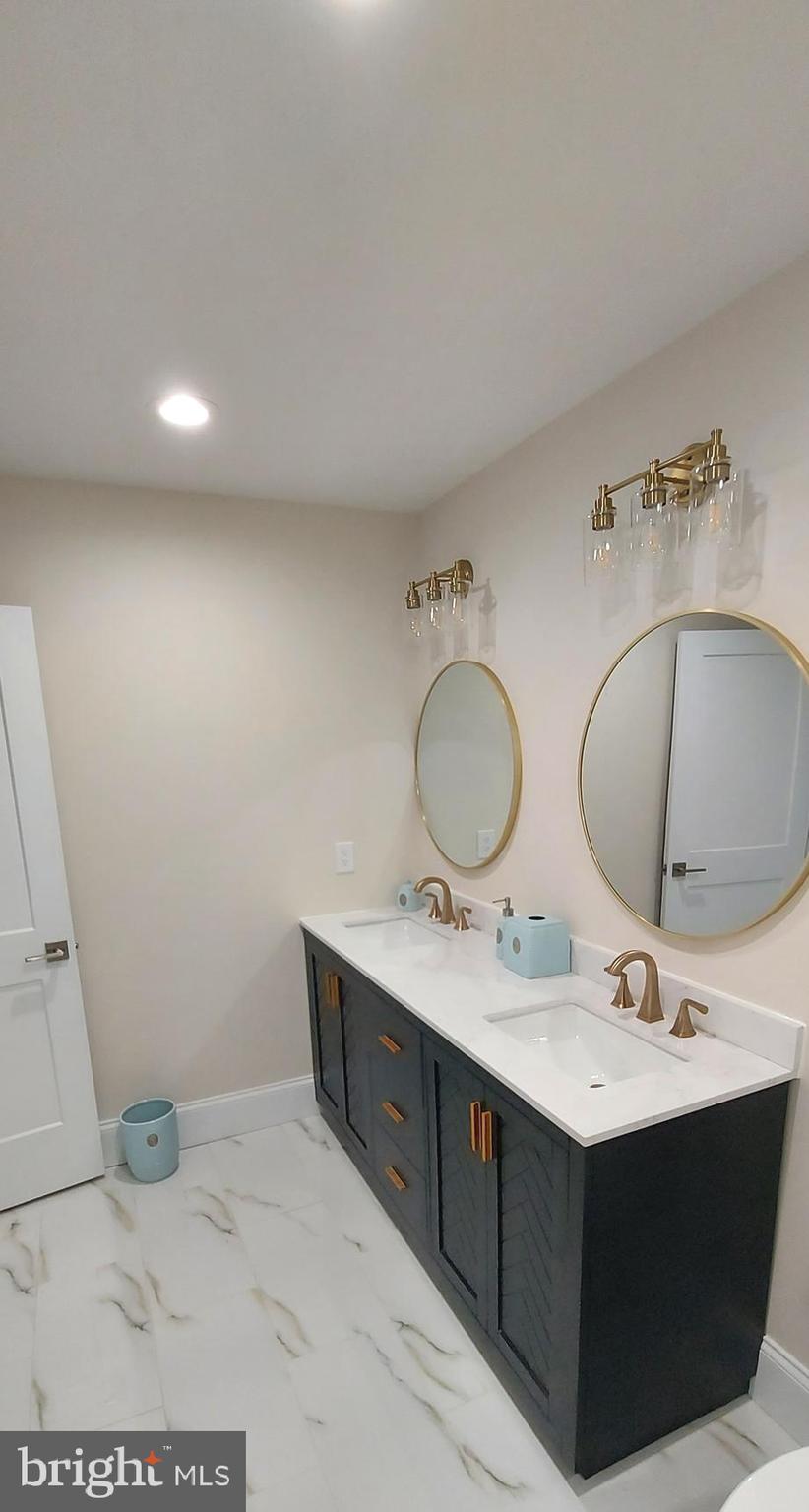 4909 Threadneedle Road Wilmington, DE 19807 - Photo 16 of 33 a bathroom with a sink vanity and a mirror