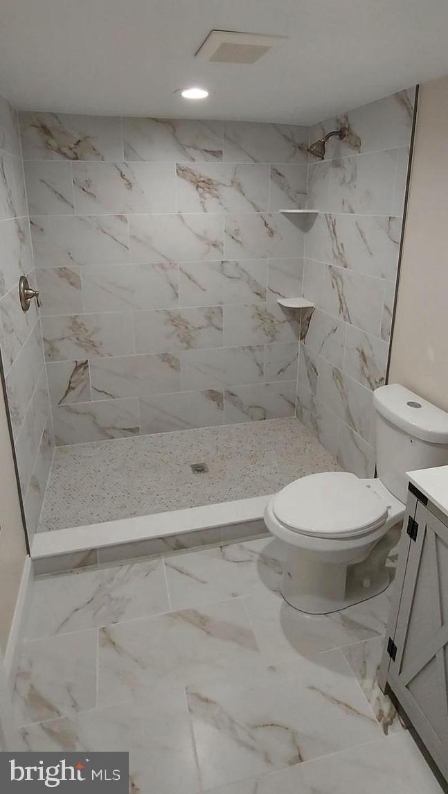 4909 Threadneedle Road Wilmington, DE 19807 - Photo 17 of 33 a white toilet sitting next to a bath tub and a shower