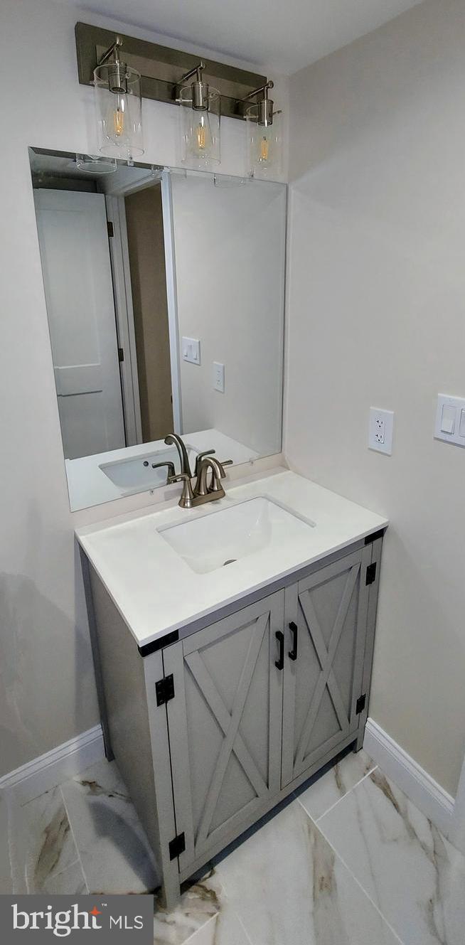 4909 Threadneedle Road Wilmington, DE 19807 - Photo 19 of 33 a bathroom with a sink a mirror and vanity
