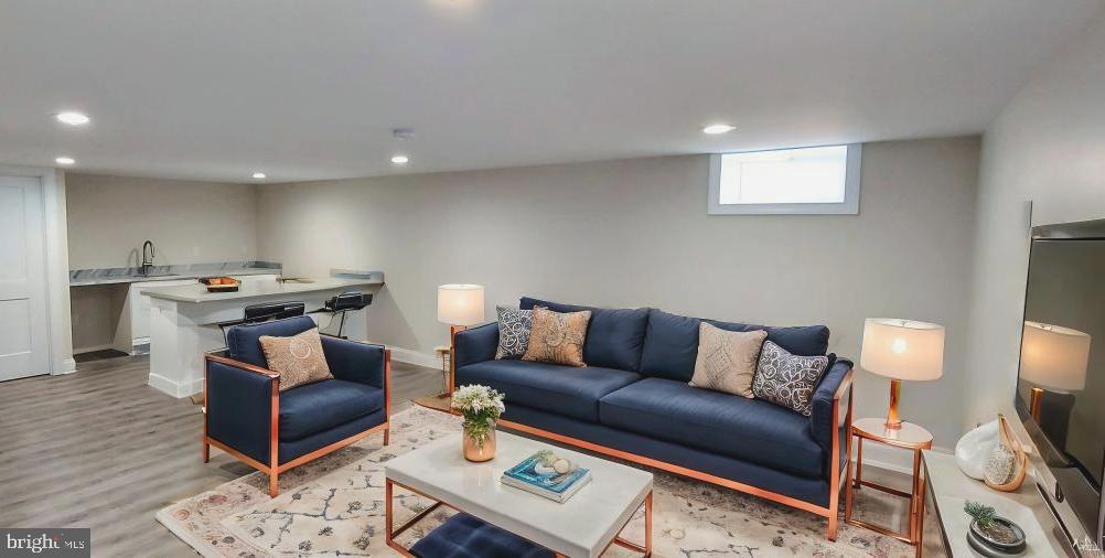 4909 Threadneedle Road Wilmington, DE 19807 - Photo 27 of 33 a living room with furniture a rug and a flat screen tv