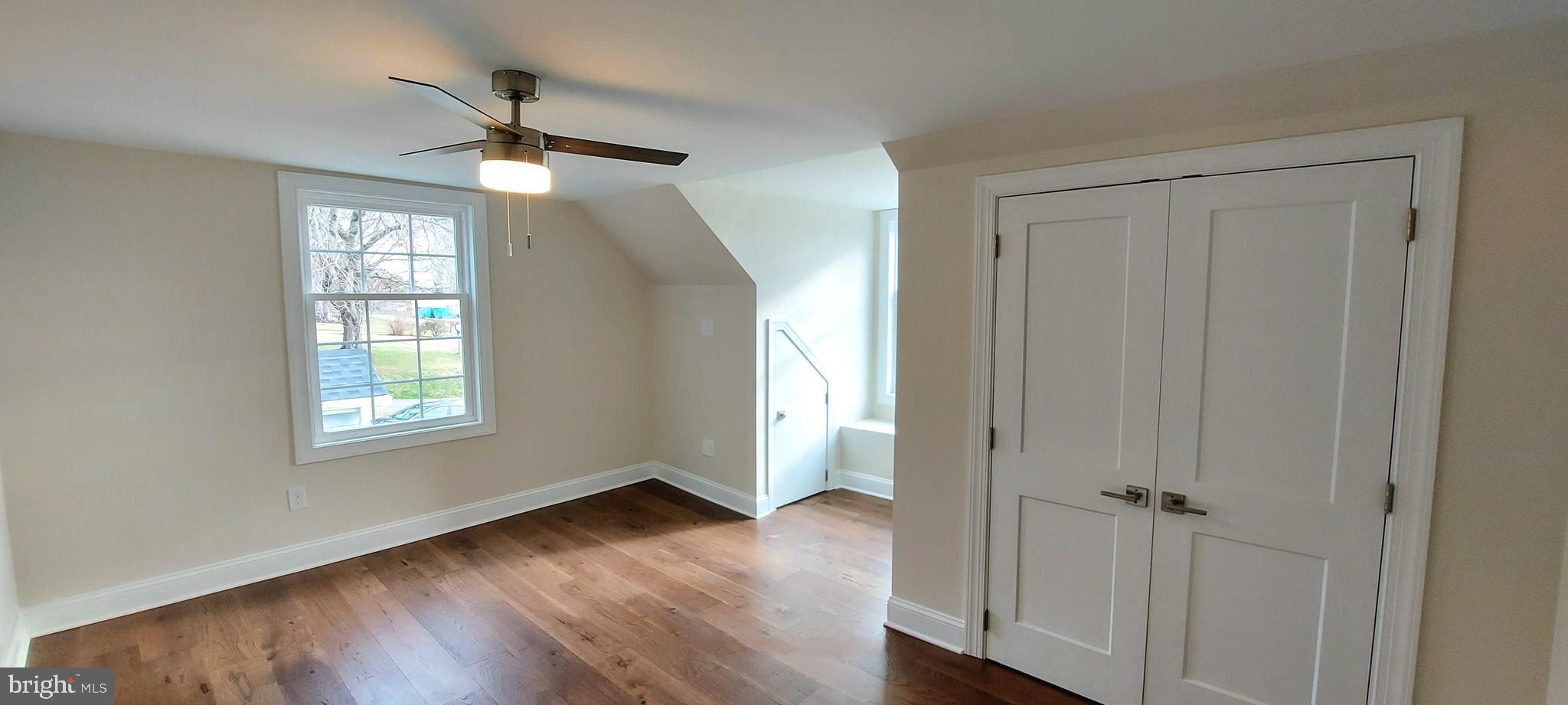 4909 Threadneedle Road Wilmington, DE 19807 - Photo 29 of 33 a view of an empty room with wooden floor and a window