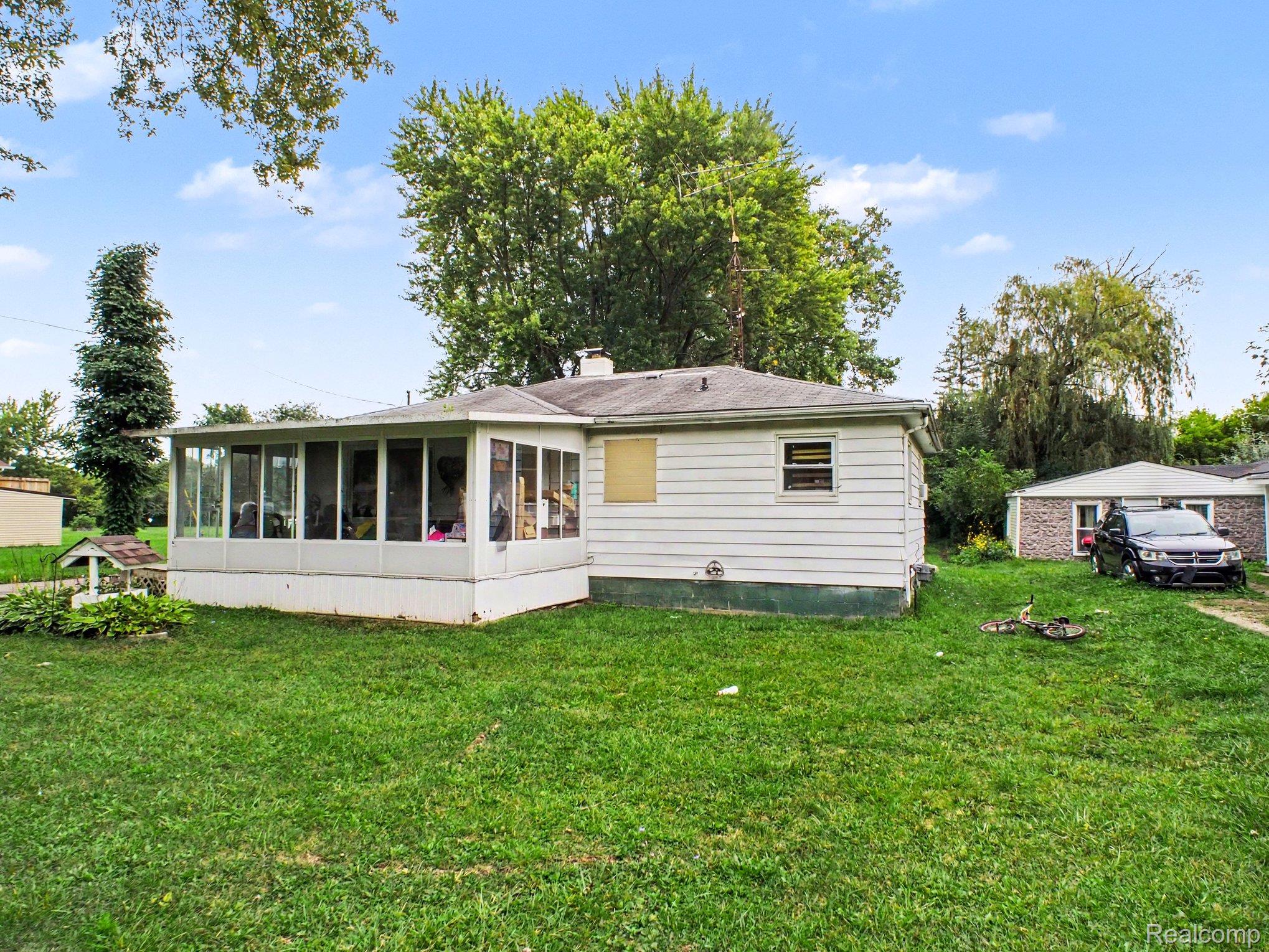 5082 North Center Road Flint, MI 48506 - Photo 19 of 21 Rear exterior featuring white siding and a screened-in porch