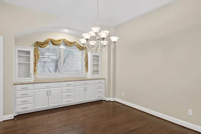 a spacious bathroom with a granite countertop sink a mirror and a vanity