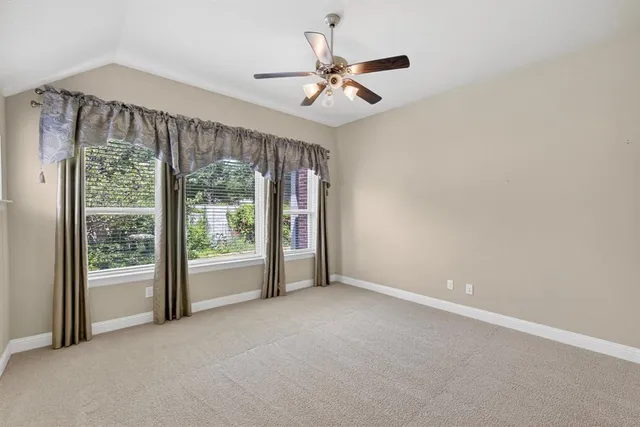 a view of a livingroom with a ceiling fan and window