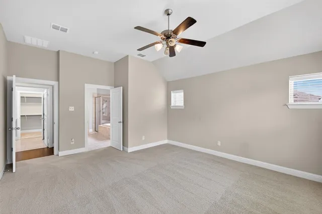 a view of an empty room with a ceiling fan