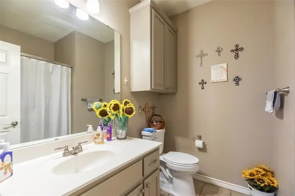 a bathroom with a sink toilet and a mirror