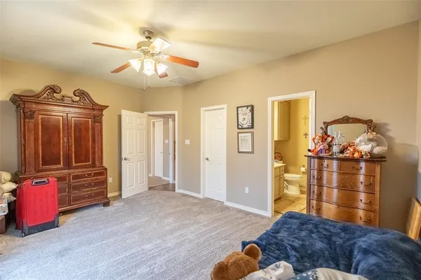 a bedroom with furniture and wooden floor