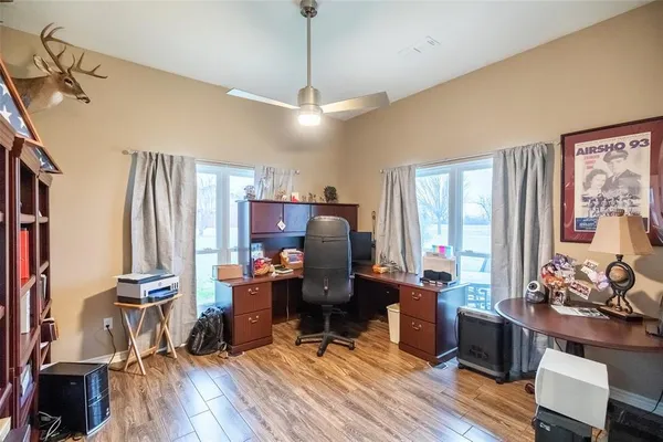 a view of a workspace with furniture and a window