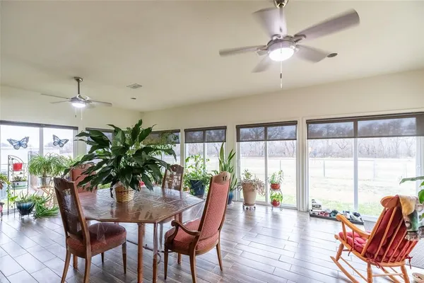 a dining room with furniture window and wooden floor