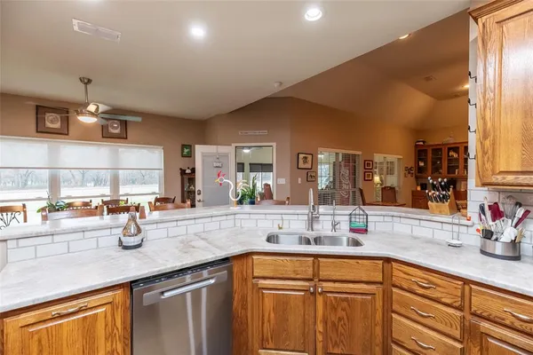 a kitchen with lots of counter top space and windows