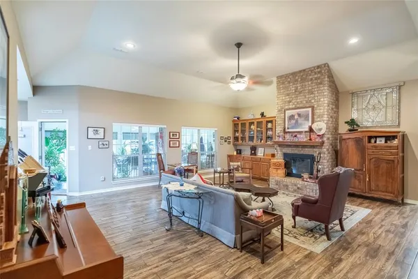 a living room with fireplace furniture and a wooden floor