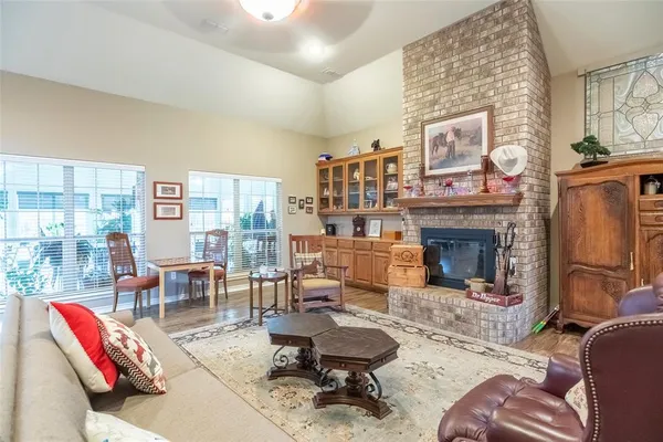 a living room with furniture a fireplace and a large mirror