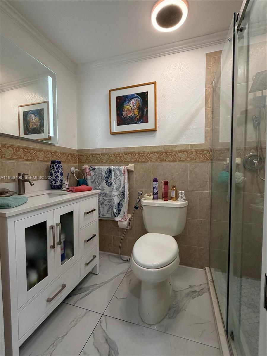 15022 Southwest 67th Lane Miami, FL 33193 - Photo 15 of 15 a bathroom with a toilet sink and mirror