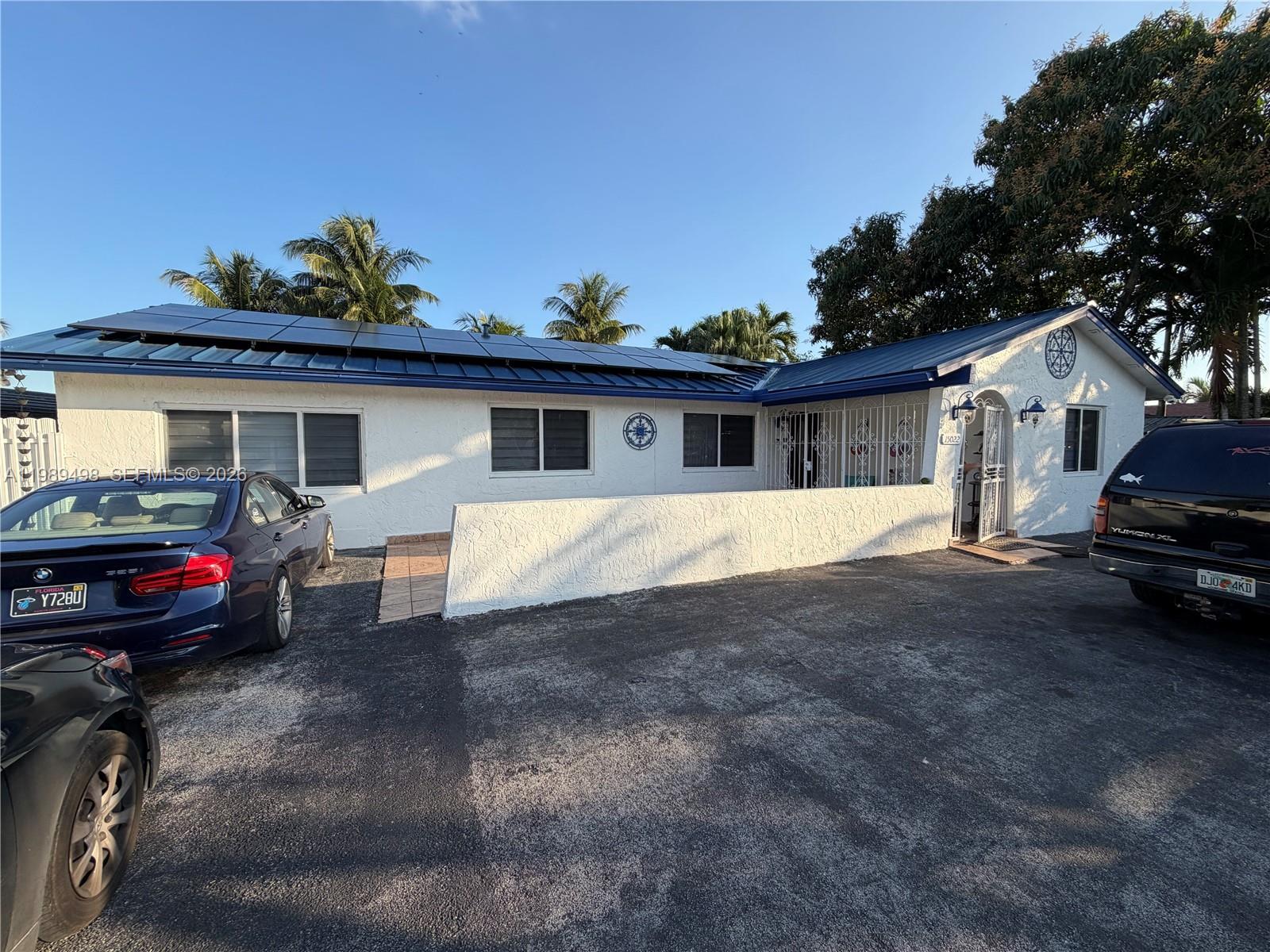 15022 Southwest 67th Lane Miami, FL 33193 - Photo 2 of 15 a view of a house with a patio and a yard