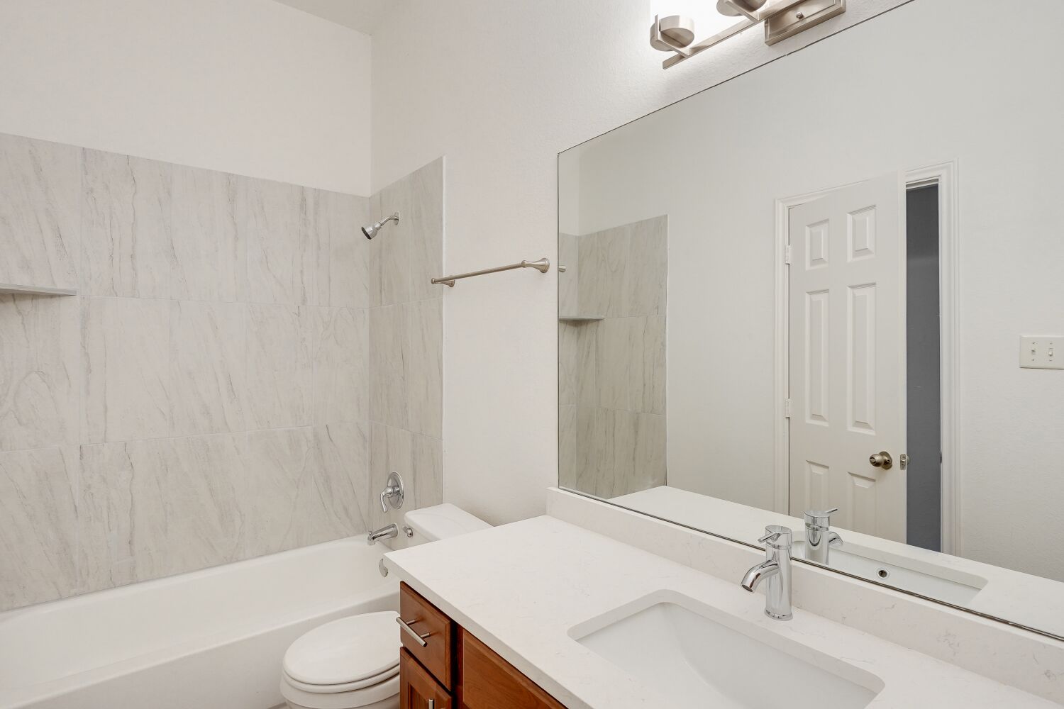 298 Fall Drive Kyle, TX 78640 - Photo 17 of 23 Full bath featuring bathing tub / shower combination and vanity with quartz countertop