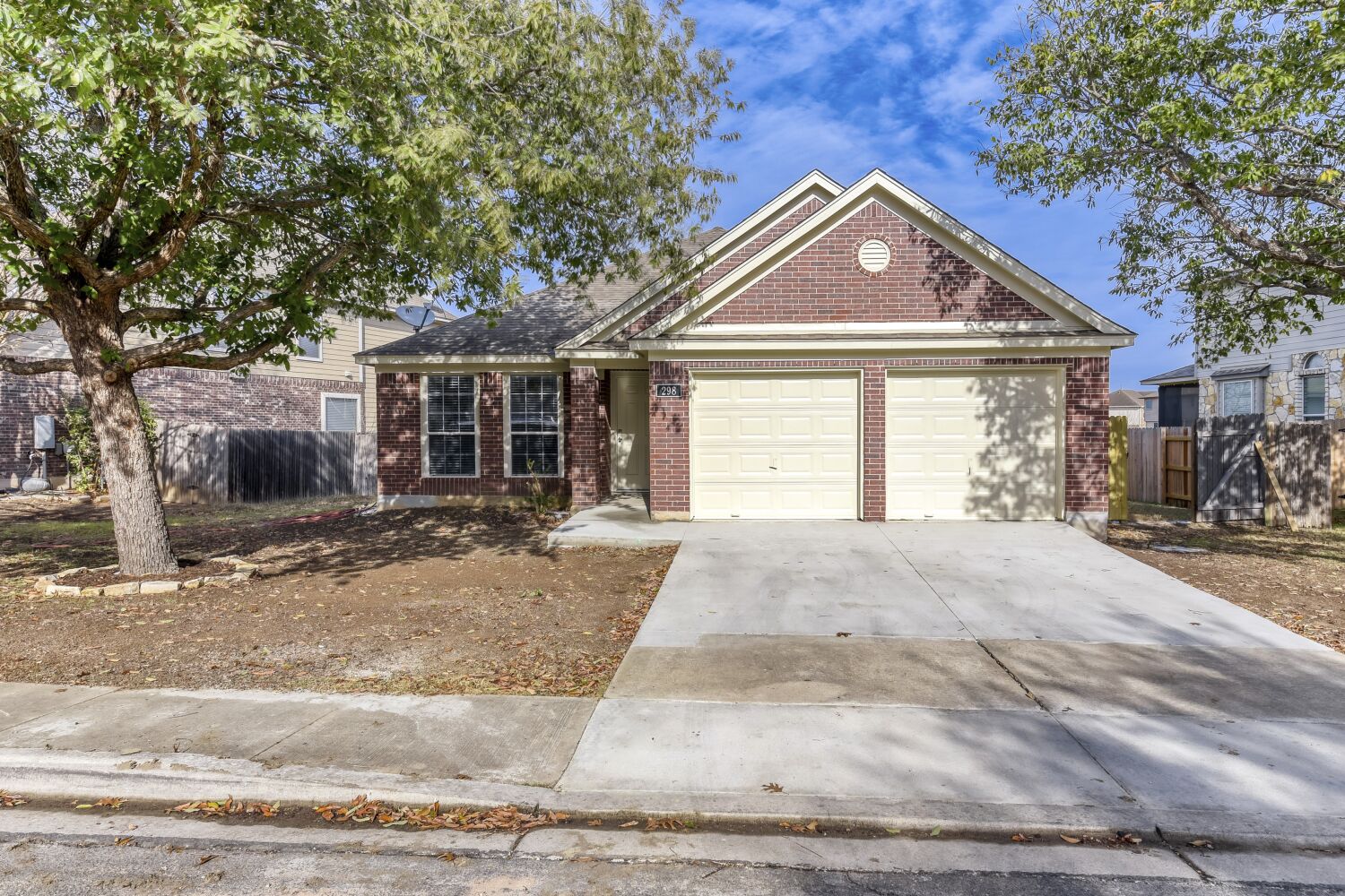298 Fall Drive Kyle, TX 78640 - Photo 19 of 23 Single story home with driveway, brick siding, and an attached garage