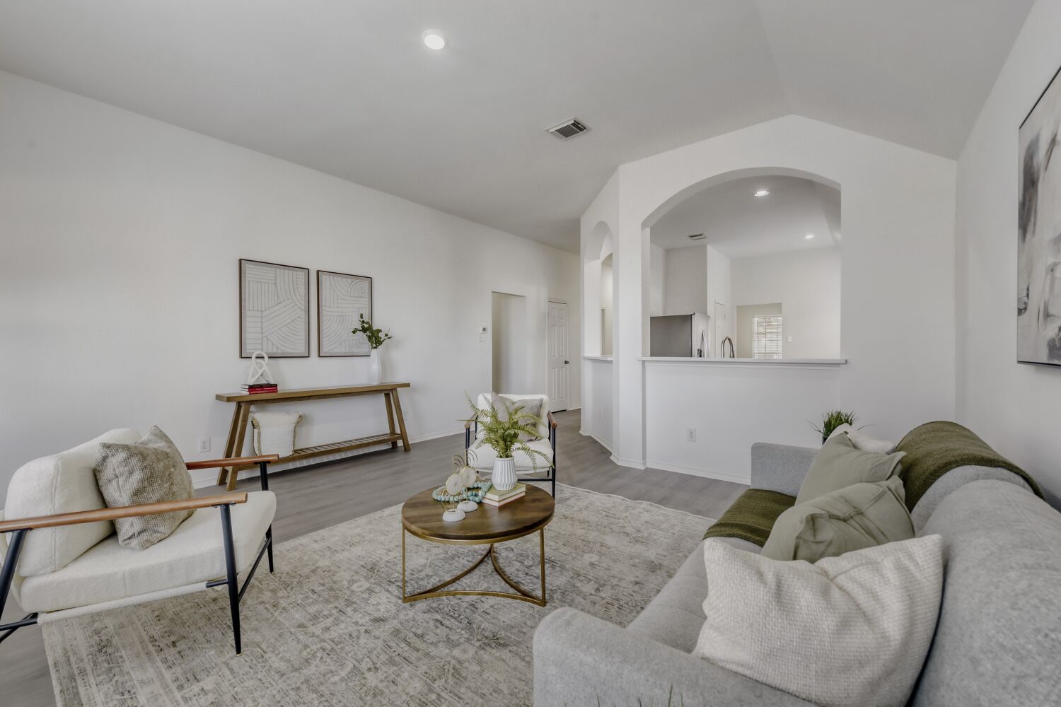 298 Fall Drive Kyle, TX 78640 - Photo 4 of 23 Living area featuring recessed lighting, wood finished floors, arched walkways, and vaulted ceiling