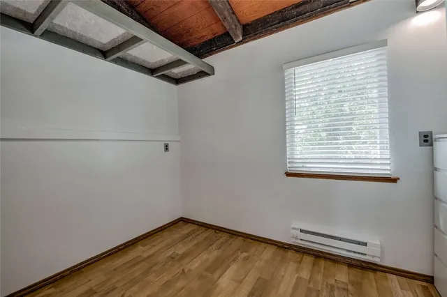 a view of a room with wooden floor and cabinet