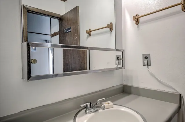 a bathroom with a sink and mirror