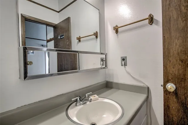 a bathroom with a sink and mirror