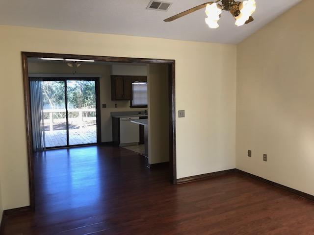 117 Beacons Bend Road Crestview, FL 32536 - Photo 30 of 30 an empty room with wooden floor cabinet and a large window