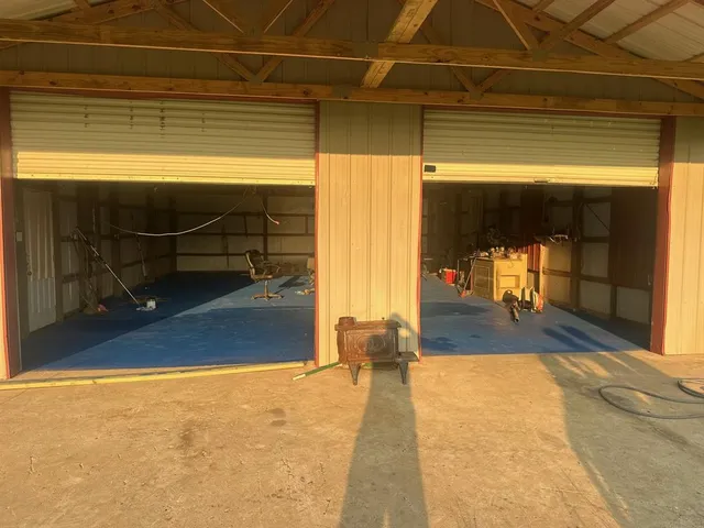 a view of a room with wooden floor and a potted plant
