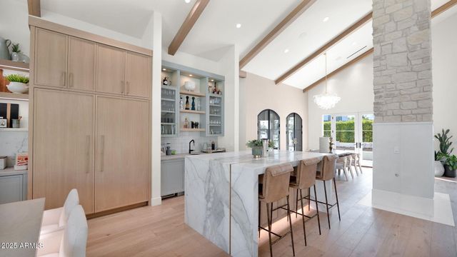 a living room with furniture a flat screen tv and a large window