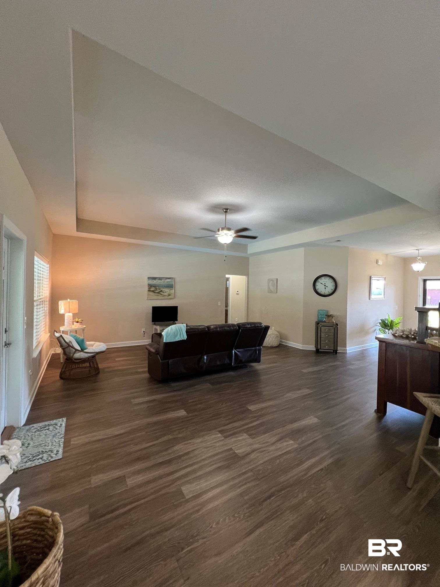 10257 Lyttleton Loop Lillian, AL 36549 - Photo 8 of 31 Living room with dark wood-style flooring, ceiling fan, and a raised ceiling