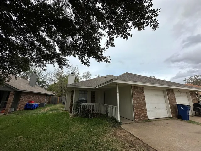 a view of a house with a yard and garage