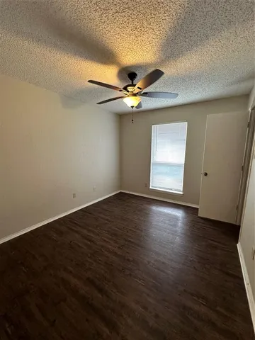 a view of a kitchen with wooden floor and a sink