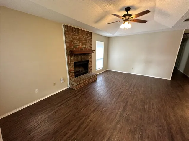 a kitchen with stainless steel appliances a stove a sink dishwasher and wooden cabinets with wooden floor