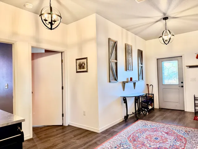 a bedroom with a bed and a flat tv screen on the wall