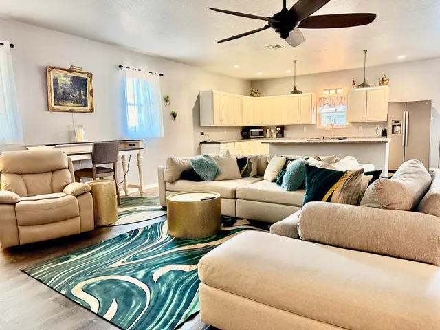 a living room with furniture and a potted plant