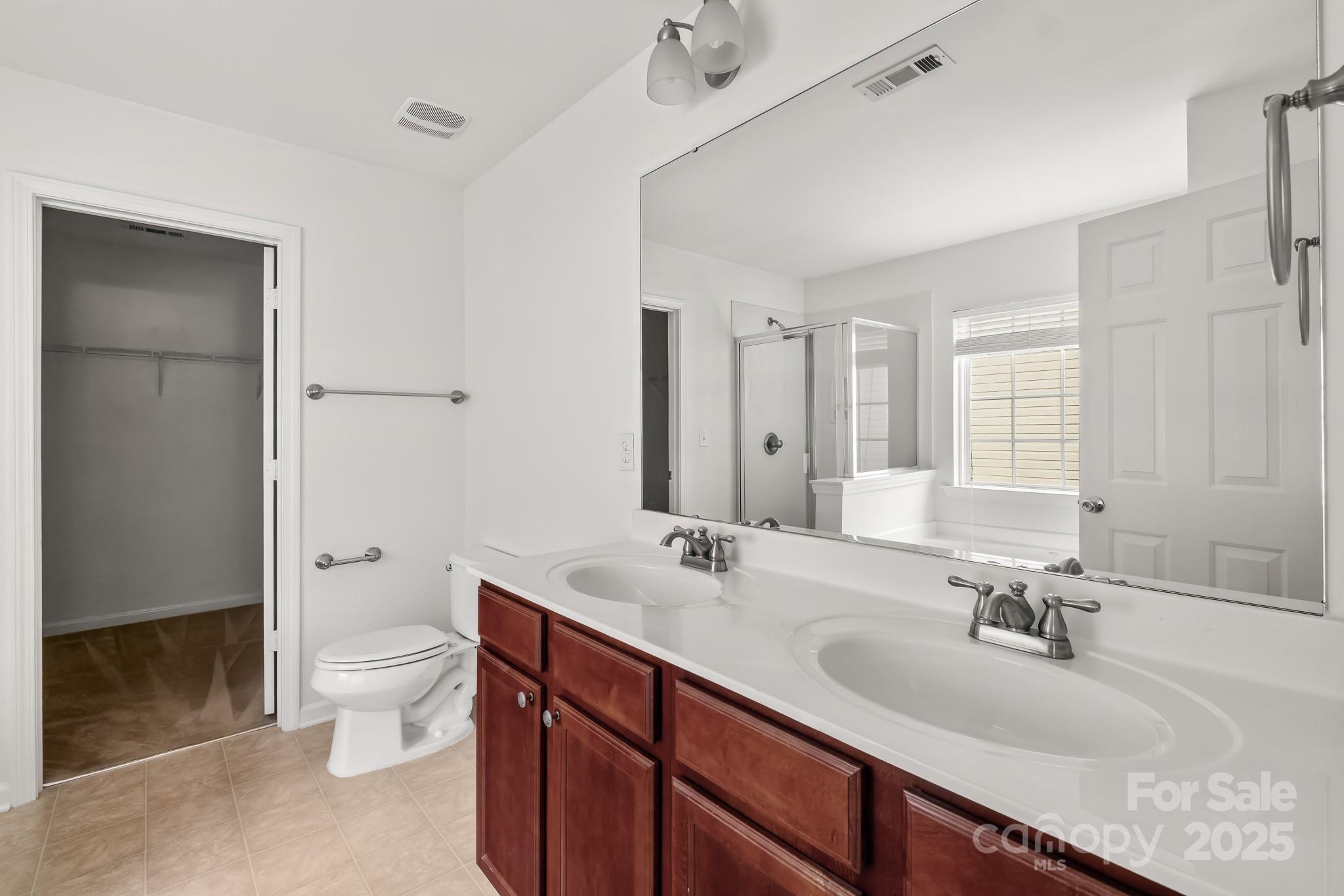 9607 Seamill Road Charlotte, NC 28278 - Photo 12 of 18 a bathroom with a double vanity sink toilet and shower