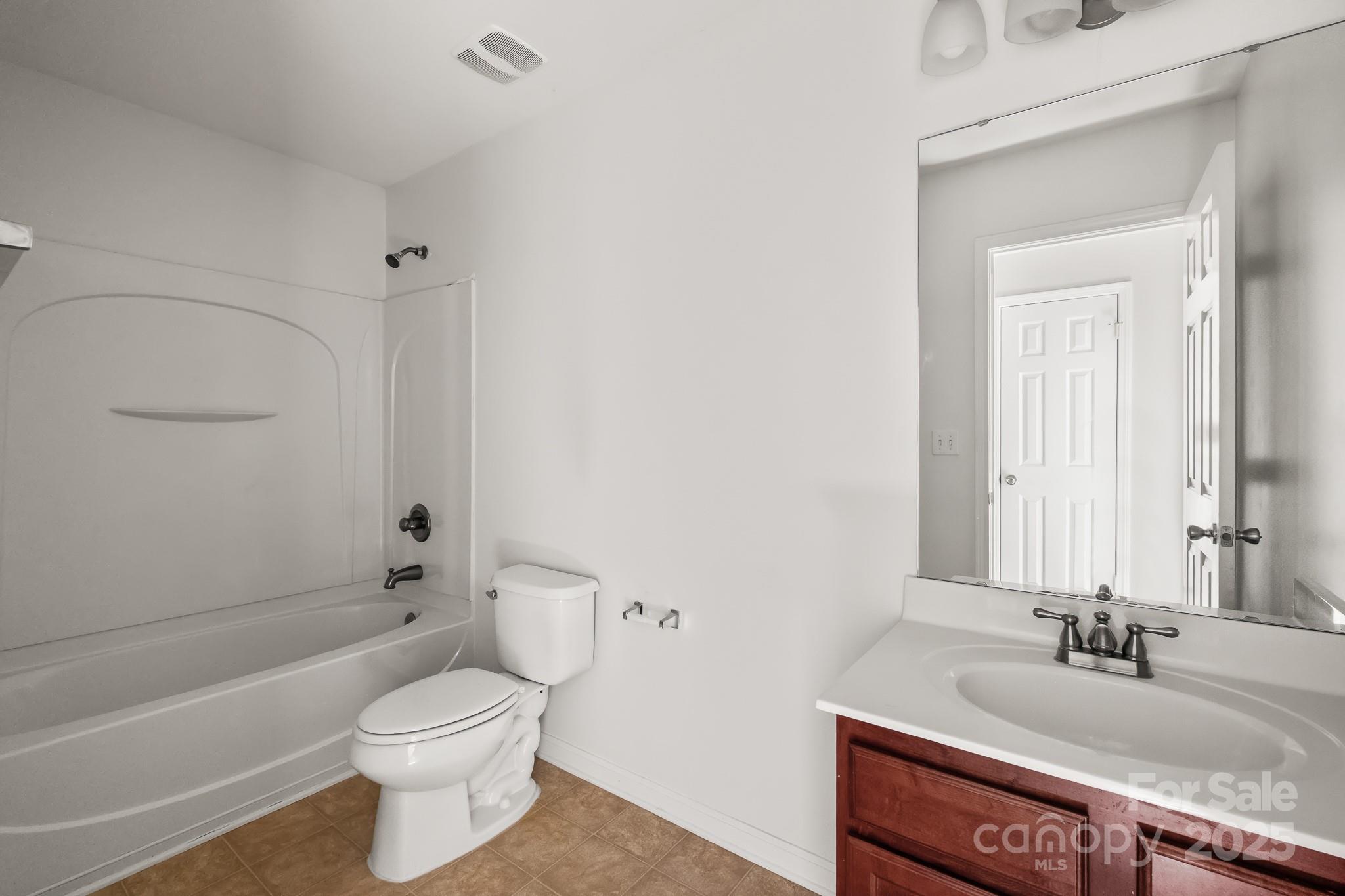9607 Seamill Road Charlotte, NC 28278 - Photo 16 of 18 a bathroom with a granite countertop sink toilet and shower