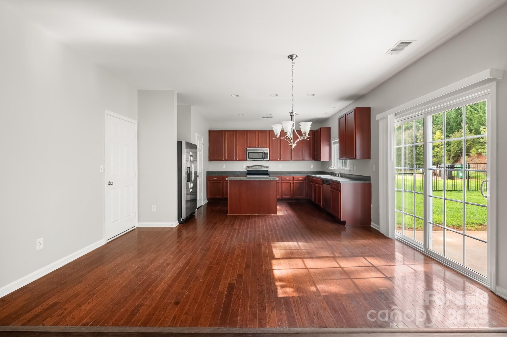 9607 Seamill Road Charlotte, NC 28278 - Photo 5 of 18 a open kitchen with stainless steel appliances granite countertop a stove and a wooden floors