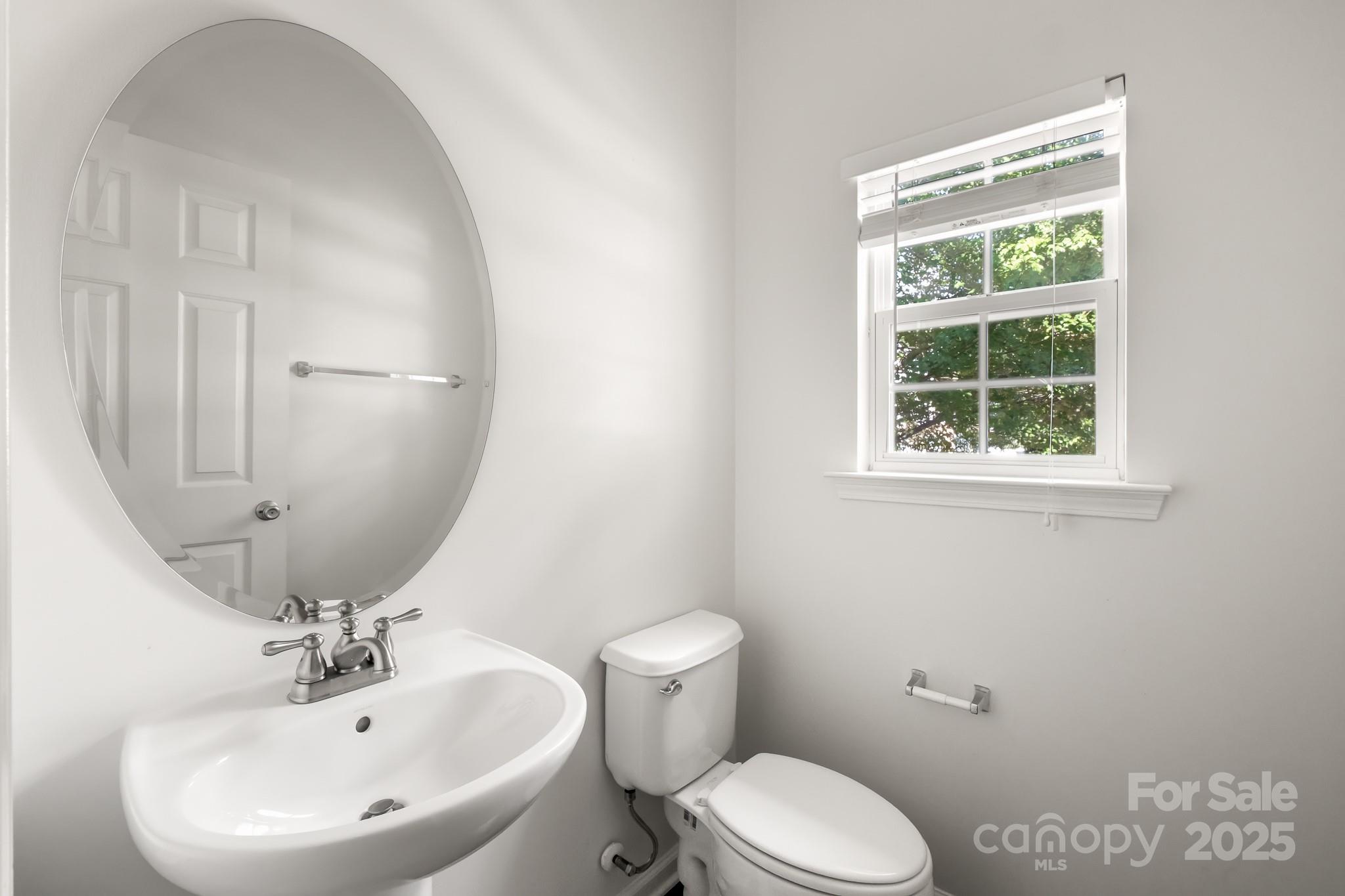 9607 Seamill Road Charlotte, NC 28278 - Photo 8 of 18 a white toilet sitting next to a bathroom sink