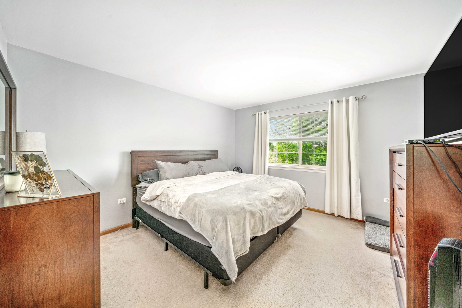 26 Rolling Oaks Road, Unit B Sugar Grove, IL 60554 - Photo 13 of 17 a bed sitting in a bedroom next to a window