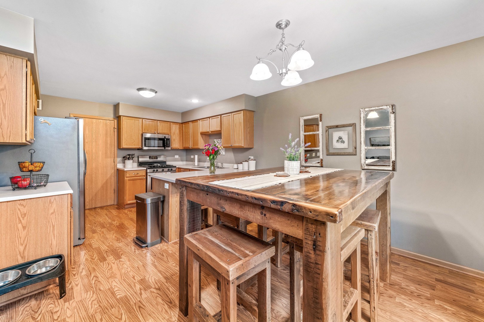 26 Rolling Oaks Road, Unit B Sugar Grove, IL 60554 - Photo 5 of 17 a kitchen with stainless steel appliances granite countertop a stove a refrigerator a kitchen island a sink dishwasher a dining table and chairs with wooden floor