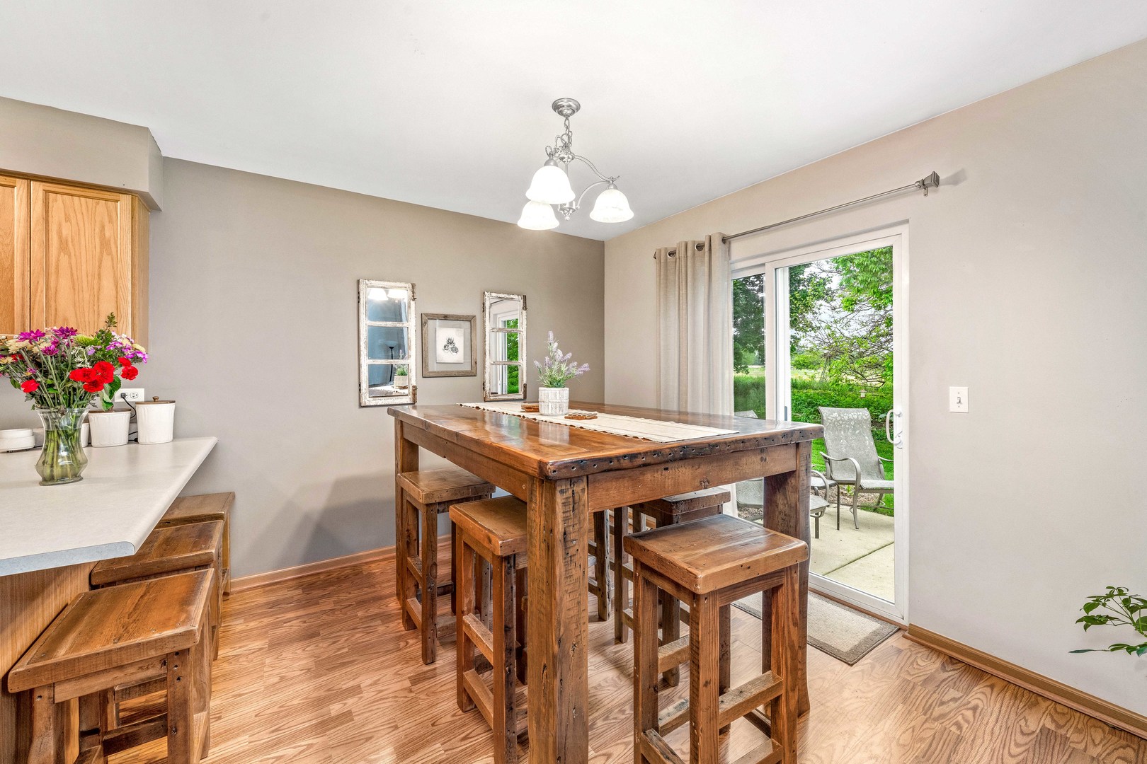 26 Rolling Oaks Road, Unit B Sugar Grove, IL 60554 - Photo 6 of 17 a dining room with wooden floor a chandelier a wooden table and chairs