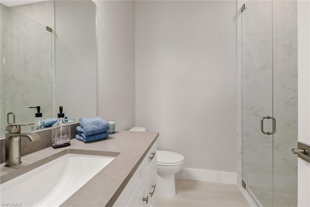 1395 Curlew Avenue, Unit 43 Naples, FL 34102 - Photo 18 of 31 a bathroom with a sink a toilet and shower