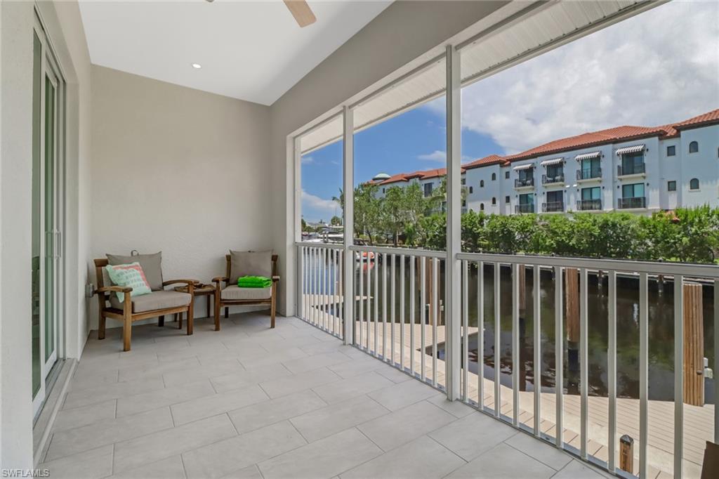 1395 Curlew Avenue, Unit 43 Naples, FL 34102 - Photo 19 of 31 a view of a patio with a table and chairs