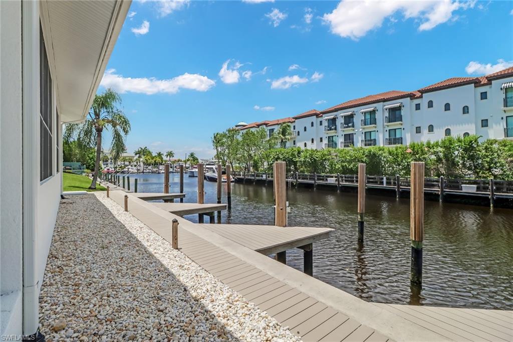 1395 Curlew Avenue, Unit 43 Naples, FL 34102 - Photo 22 of 31 a view of a lake with a house