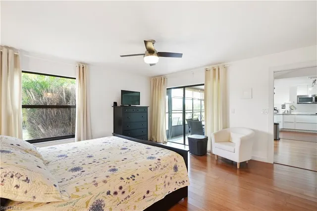 a bedroom with a bed and a large window with outer view