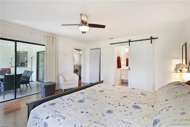 a bedroom with a bed and a dresser with mirror