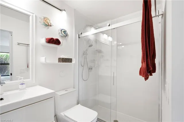 a bathroom with a shower toilet and sink