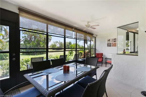 a view of a dining room with furniture large windows and wooden floor